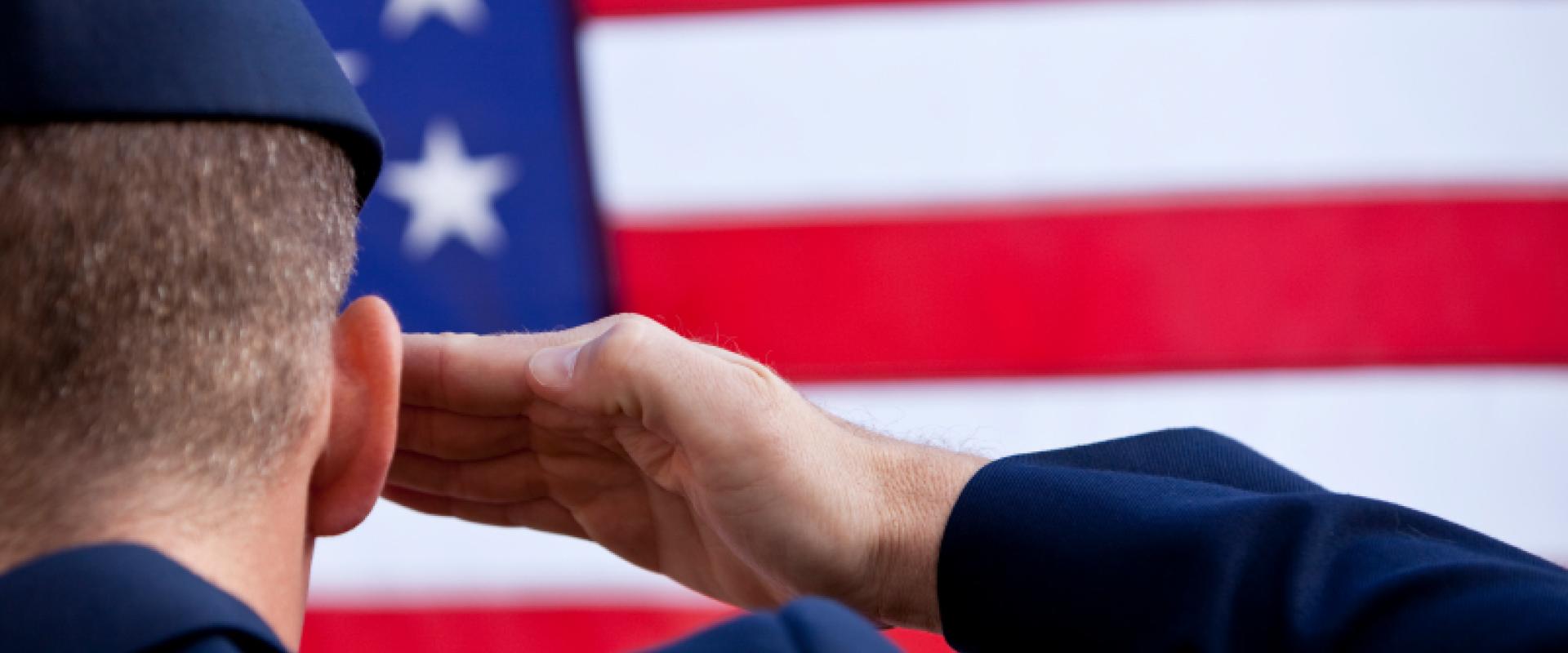 soldier saluting the US flag